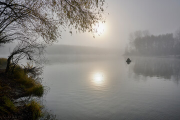 Foggy dawn in autumn by the river.