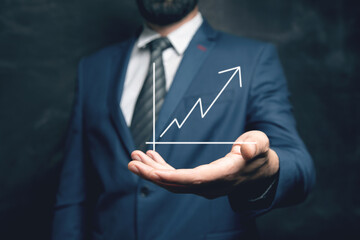 hand holding a chart with an arrow pointing up