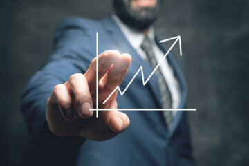 hand holding a chart with an arrow pointing up