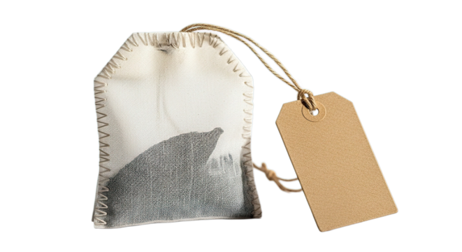 Aged handmade fabric tea bag with empty tag isolated on transparent background