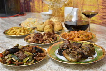 Braised beef, Chinese beef appetizers, fish and vegetable dishes, dumplings, red wine in decanter