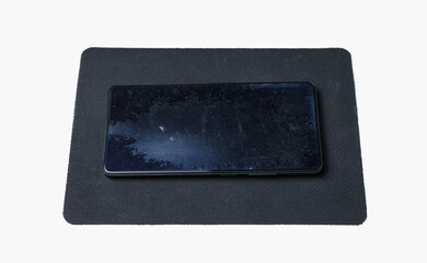 A smartphone with a badly worn screen protector.