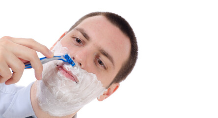 Man shaving with razor and foam