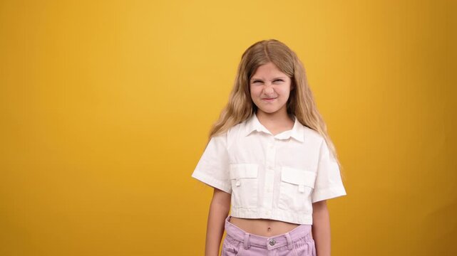 Playful young girl making funny faces and smiling at camera