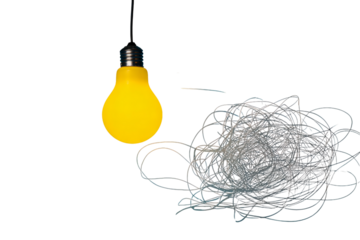 Bright yellow lightbulb illuminates tangled mess of string against dark backdrop