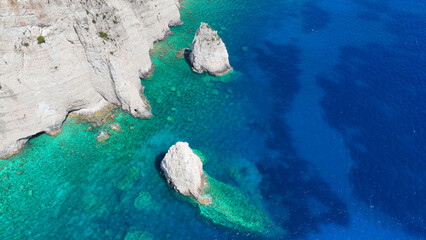 Aerial drone photo of scenic paradise bay with white rocky seascape forming small caves surrounded...