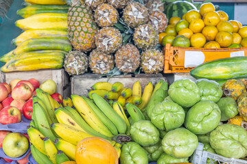 Colorful display of fresh fruits at the Otavalo market, Ecuador. A vibrant scene that conveys freshness, abundance, and natural flavor.