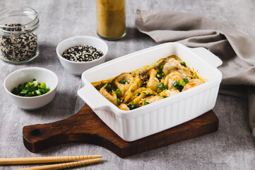 One-Pan Baked Dumplings with Herbs and Sauce in a Pan on the Table