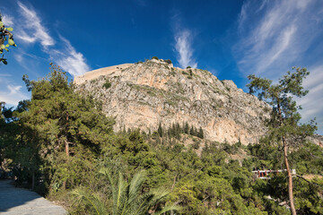 Palamidi fortress on rocky hill above lush forest in Nafplio, Peloponnese, Greece