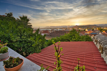 Sunset View Over Tiled Rooftops and Gardens in Nafplio, Greece