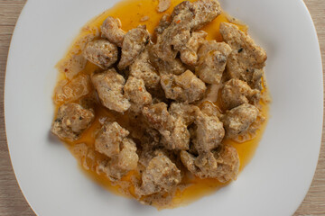 Gourmet Turkish Chicken Stew with Creamy Sauce on a White Plate