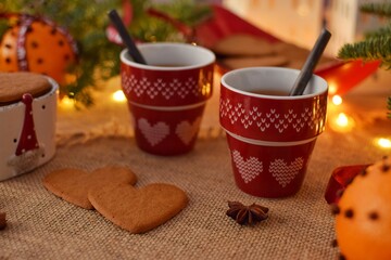 Mulled wine in a small red mugs and Swedish gingerbread,Pepparkakor. Time to drink mulled wine.