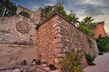 Historic stone wall and narrow street in Nafplio, Peloponnese, Greece