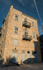 Historic stone building with blue shutters in Nafplio, Peloponnese, Greece
