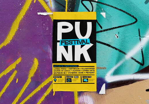 Mockup of A blank vertical poster fixed on a vibrant, graffiti-covered wall. 