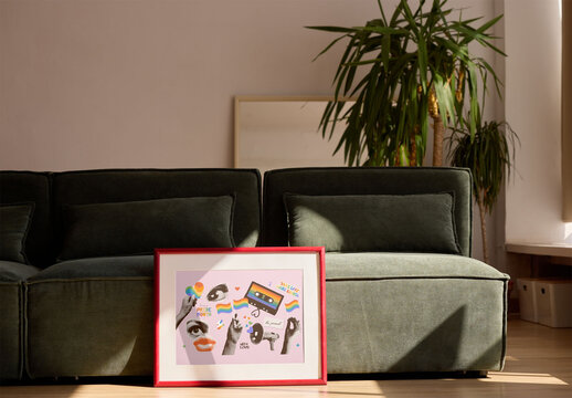 A cozy living room scene features a green sofa and a blank frame