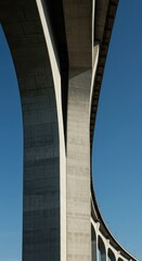 Obraz premium Detailed view of massive concrete support pillars and curved arches of a large infrastructure project providing a strong geometric background, underpass, setting, span