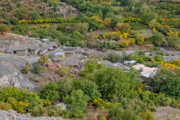 Traditional rural life in a Kurdish village, featuring a weathered stone and wood shelter and a dirt path