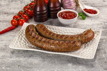 Grilled beef sausages with sauce