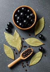 A collection of aromatic, black bay laurel berries and dried leaves, ingredients for essential oils and unique culinary seasoning, organic, laurel, seasoning