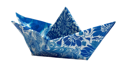 PNG of A beautifully crafted origami boat in intricate blue and white floral patterns, showcasing elegance and creativity.