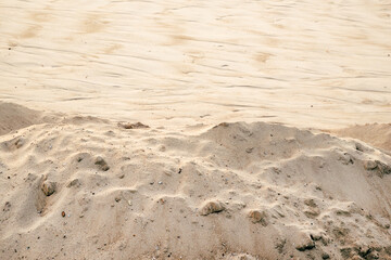 Natural sand formation with fine ripples and erosion lines shaped by wind, creating an organic desert texture.