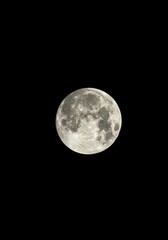 Fototapeta premium Majestic, perfectly round full moon suspended in the vast, deep black abyss of the nocturnal space, highlighting celestial crater details ,illuminated ,abstract ,atmosphere