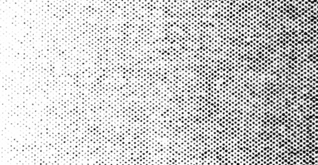 Black halftone dots with rough edges forming a gradient pattern on a transparent background.