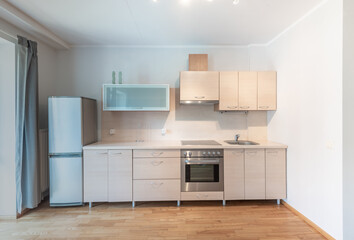 Modern Minimalist Home Kitchen with Appliances and Wooden Cabinets in Bright Interior