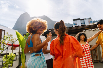 Group of friends dancing on a rooftop in Rio de Janeiro