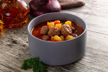 Tomato soup with meatballs and vegetables
