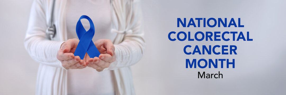 Doctors Hands Presenting Blue Awareness Ribbon - Colorectal Cancer Awareness Concept