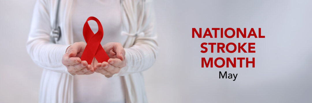 Doctors Hands Presenting Red Awareness Ribbon - Stroke Awareness Concept