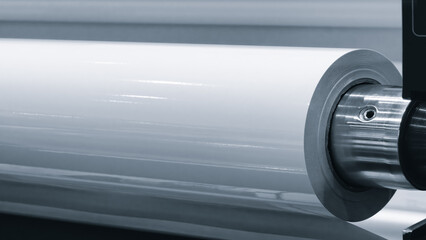 Industrial wide-format printing machine prints advertising posters or banners on paper, advertising...