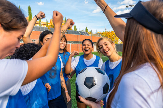 Female soccer team players celebrating victory with ball - Powered by Adobe