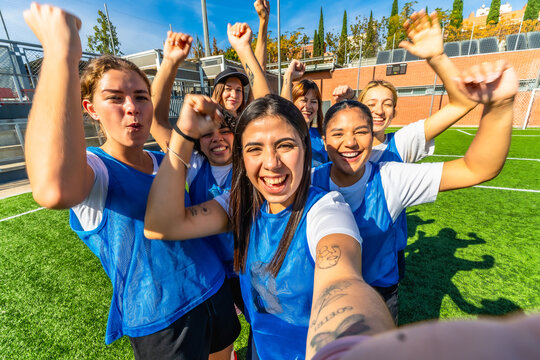 Women's soccer team celebrating victory on field