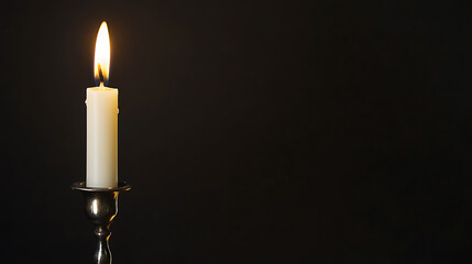 Illuminating the darkness, a single candle flame flickers, casting a warm glow against the stark black backdrop. Symbolizing hope, remembrance, or tranquility, its simple beauty endures.