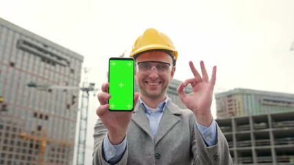 Construction manager is approving smartphone application during on-site audit