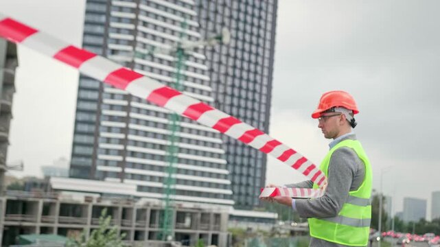Foreman cordoning off new development site for safety purposes