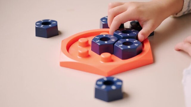 girl solving logic puzzle, Children hands playing with educational math STEM game using pieces learning number composition seven practicing logic thinking fun cognitive activity and math skills