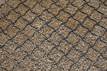Polymer geogrid reinforcement over gravel surface for soil stabilization. For erosion control, road construction, and permeable pavement systems. Real photo