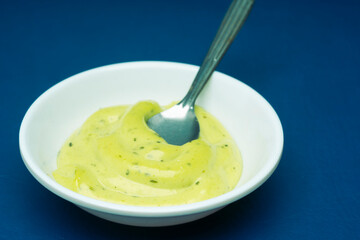 Guacamole sauce on blue background
