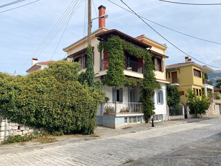 Charming mediterranean house with vines on a sunny street corner