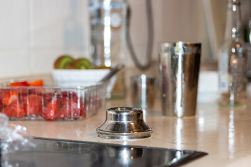 Preparing a delicious fruit cocktail at home bar