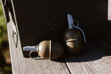 Ammo can and grenades symbolize strategic readiness. A concept for military, defense, and security.