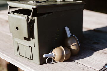 Ammo can and grenades symbolize strategic readiness. A concept for military, defense, and security.
