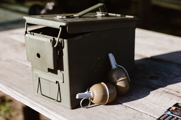 Ammo can and grenades symbolize strategic readiness. A concept for military, defense, and security.