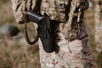 A soldier's pistol in a tactical holster.