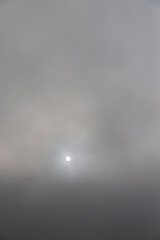 autumn gray sky covered with thick clouds and thick fog that slowly dissipates from sunlight,...