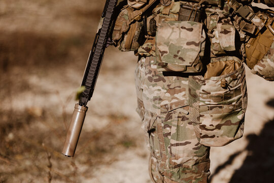 A soldier in camouflage and tactical gear. Concept for modern warfare, defense, and global security